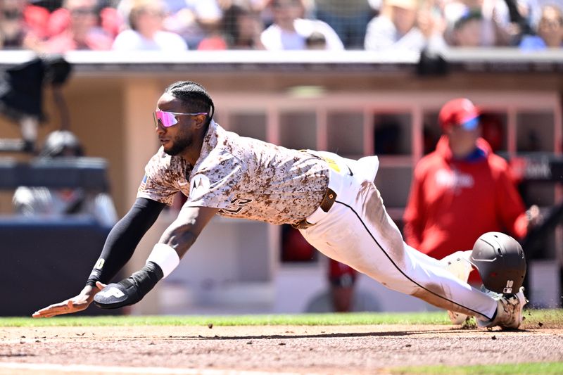 Apr 28, 2024; San Diego, California, USA; San Diego Padres left fielder Jurickson Profar (10) slides home to score a run against the Philadelphia Phillies during the third inning at Petco Park. Mandatory Credit: Orlando Ramirez-USA TODAY Sports