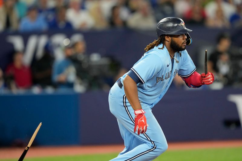 Jul 18, 2023; Toronto, Ontario, CAN; Toronto Blue Jays dfirst baseman Vladimir Guerrero Jr. (27) heads to first base with a broken bat against the San Diego Padres during the sixth inning at Rogers Centre. Mandatory Credit: John E. Sokolowski-USA TODAY Sports