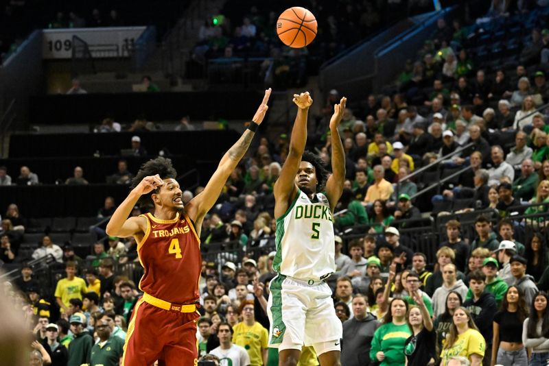 Dec 2, 2025; Eugene, Oregon, USA; Oregon Ducks guard Takai Simpkins (5) shoots the ball against defense by Southern California Trojans forward Chad Baker-Mazara (4) during the first half at Matthew Knight Arena. Mandatory Credit: Craig Strobeck-Imagn Images