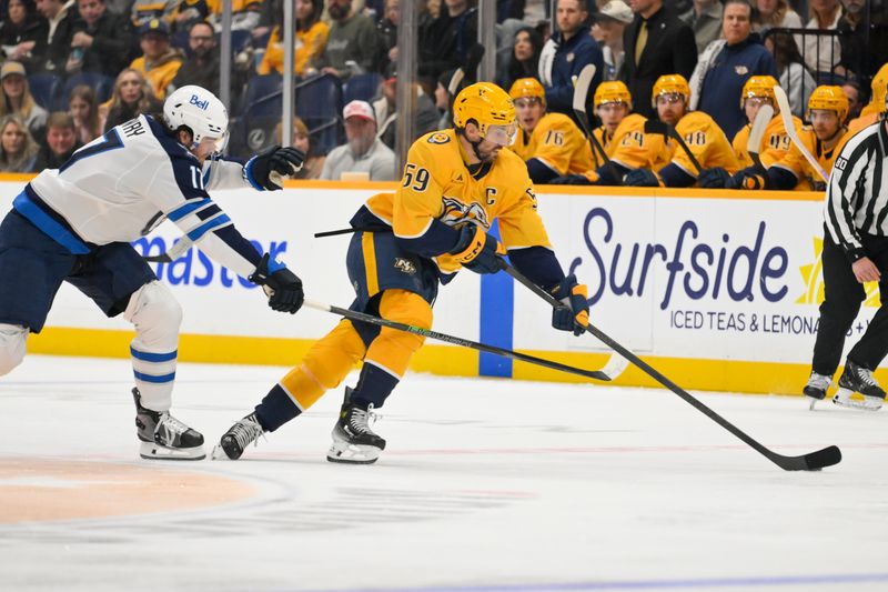 Nov 29, 2025; Nashville, Tennessee, USA;  Nashville Predators defenseman Roman Josi (59) skates with the puck against Winnipeg Jets center Adam Lowry (17) during the first period at Bridgestone Arena. Mandatory Credit: Steve Roberts-Imagn Images