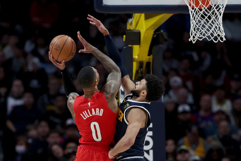 DENVER, COLORADO - JANUARY 17: Damian Lillard #0 of the Portland Trail Blazers goes to the basket against Jamal Murray #27 of the Denver Nuggets in the third quarter at Ball Arena on January 17, 2023 in Denver, Colorado. NOTE TO USER: User expressly acknowledges and agrees that, by downloading and/or using this photograph, User is consenting to the terms and conditions of the Getty Images License Agreement. (Photo by Matthew Stockman/Getty Images)