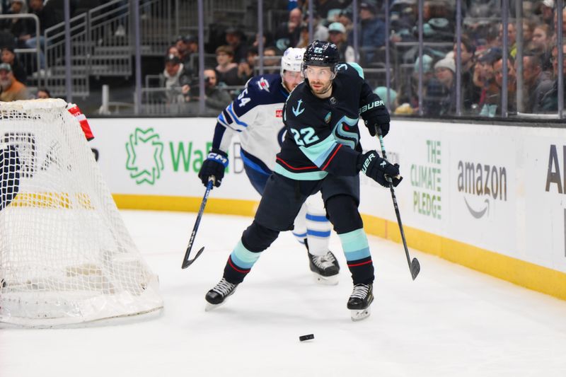 Mar 8, 2024; Seattle, Washington, USA; Seattle Kraken right wing Oliver Bjorkstrand (22) plays the puck during the second period against the Winnipeg Jets at Climate Pledge Arena. Mandatory Credit: Steven Bisig-USA TODAY Sports