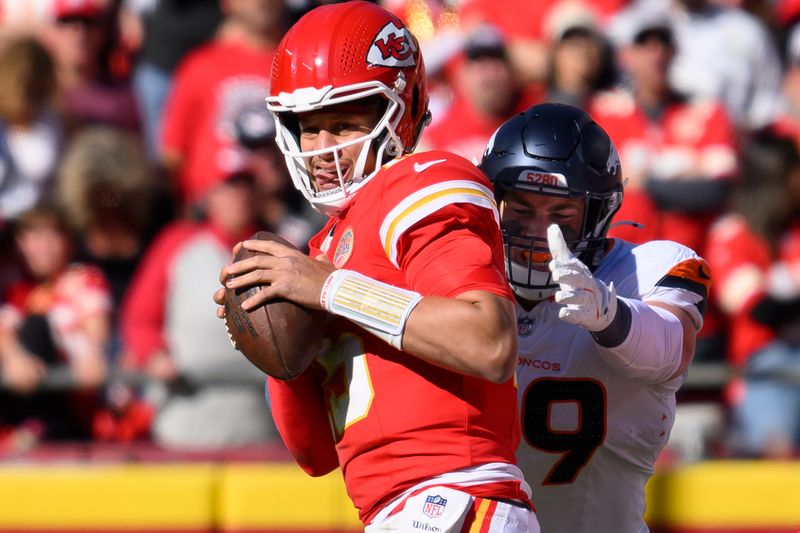 Kansas City Chiefs quarterback Patrick Mahomes (15) is sacked by Denver Broncos defensive end Zach Allen (99) during the first half of an NFL football game, Sunday, Nov. 10, 2024 in Kansas City, Mo. (AP Photo/Reed Hoffmann)