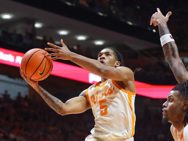 Feb 28, 2024; Knoxville, Tennessee, USA; Tennessee Volunteers guard Zakai Zeigler (5) goes to the basket against the Auburn Tigers during the second half at Thompson-Boling Arena at Food City Center. Mandatory Credit: Randy Sartin-USA TODAY Sports