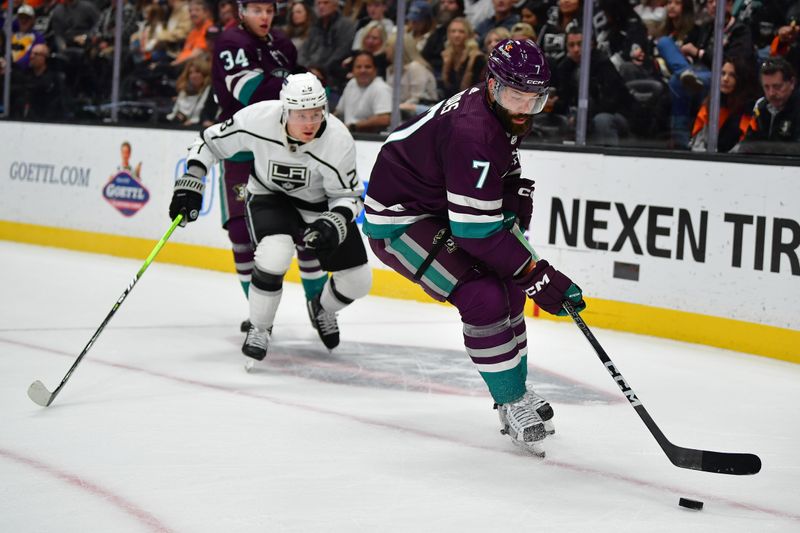 Nov 24, 2023; Anaheim, California, USA; Anaheim Ducks defenseman Radko Gudas (7) moves the puck ahead of Los Angeles Kings center Jaret Anderson -Dolan (28) during the first period at Honda Center. Mandatory Credit: Gary A. Vasquez-USA TODAY Sports