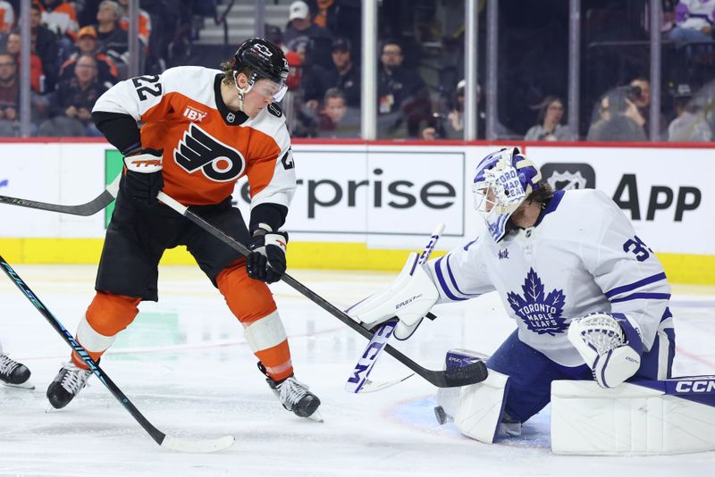 Jan 8, 2026; Philadelphia, Pennsylvania, USA; Toronto Maple Leafs goaltender Dennis Hildeby (35) makes a save on Philadelphia Flyers center Christian Dvorak (22) during the third period at Xfinity Mobile Arena. Mandatory Credit: Bill Streicher-Imagn Images