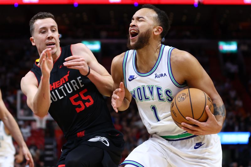 MIAMI, FLORIDA - DECEMBER 18: Kyle Anderson #1 of the Minnesota Timberwolves drives against Duncan Robinson #55 of the Miami Heat during the first quarter of the game at Kaseya Center on December 18, 2023 in Miami, Florida. NOTE TO USER: User expressly acknowledges and agrees that, by downloading and or using this photograph, User is consenting to the terms and conditions of the Getty Images License Agreement. (Photo by Megan Briggs/Getty Images)