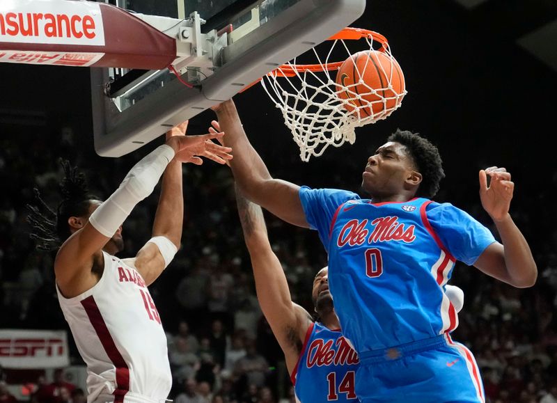 Jan 14, 2025; Tuscaloosa, AL, USA; Alabama forward Jarin Stevenson (15) dunks against Ole Miss guard Dre Davis (14) and Ole Miss forward Malik Dia (0) at Coleman Coliseum. Ole Miss defeated Alabama 74-64. Mandatory Credit: Gary Cosby Jr./USA TODAY Network via Imagn Images