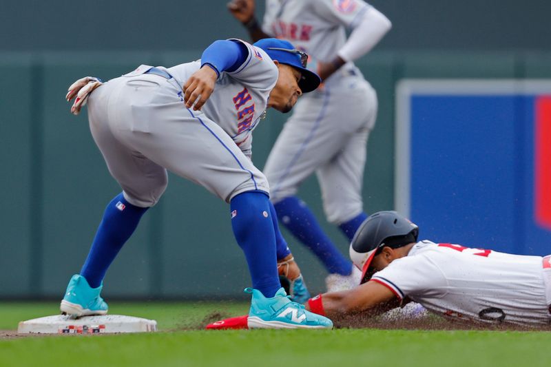 Sep 9, 2023; Minneapolis, Minnesota, USA; New York Mets shortstop Francisco Lindor (12) tags out Minnesota Twins center fielder Willi Castro (50) on an attempt to steal second base in the seventh inning at Target Field. Mandatory Credit: Bruce Kluckhohn-USA TODAY Sports