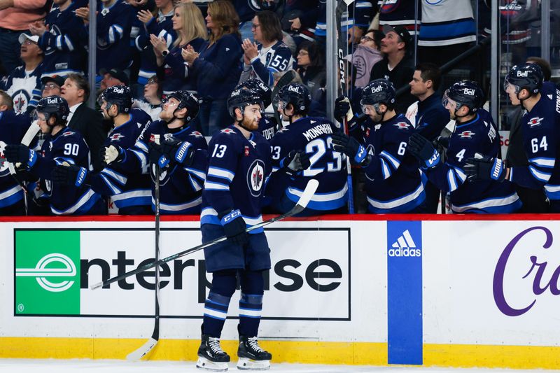 Apr 18, 2024; Winnipeg, Manitoba, CAN;  Winnipeg Jets forward Gabriel Vilardi (13) is congratulated by his team mates on his goal against Vancouver Canucks goalie Thatcher Demko (not pictured) during the first period at Canada Life Centre. Mandatory Credit: Terrence Lee-USA TODAY Sports