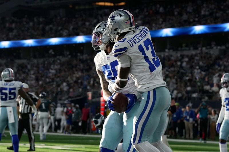 Dallas Cowboys linebacker Marist Liufau (35) and linebacker DeMarvion Overshown (13) celebrate after Liufau recovered a Philadelphia Eagles' Jalen Hurts fumble in the first half of an NFL football game in Arlington, Texas, Sunday, Nov. 10, 2024. (AP Photo/Jeffrey McWhorter)