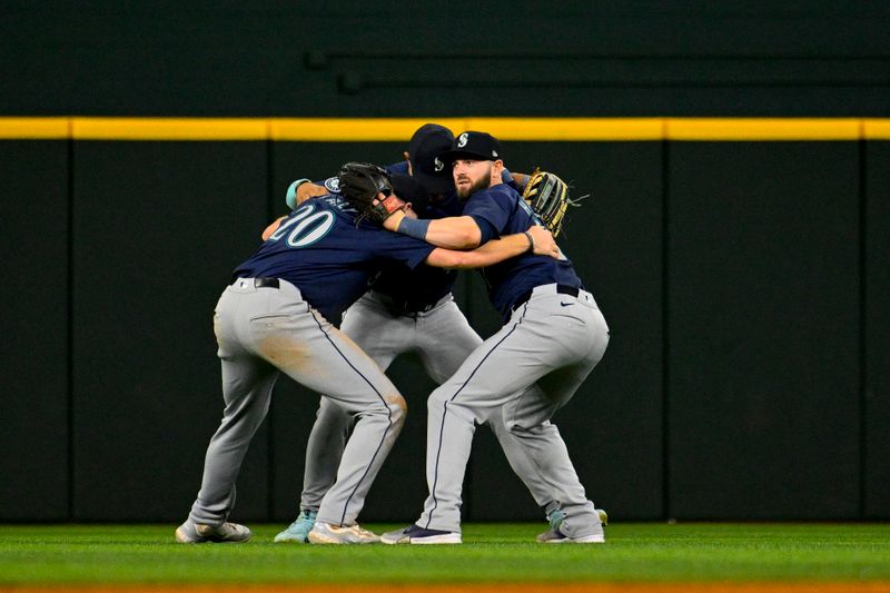 Apr 23, 2024; Arlington, Texas, USA; Seattle Mariners left fielder Luke Raley (20) and center fielder Julio Rodriguez (44) and right fielder Mitch Haniger (17) celebrate on the field after Seattle defeats the Texas Rangers at Globe Life Field. Mandatory Credit: Jerome Miron-USA TODAY Sports