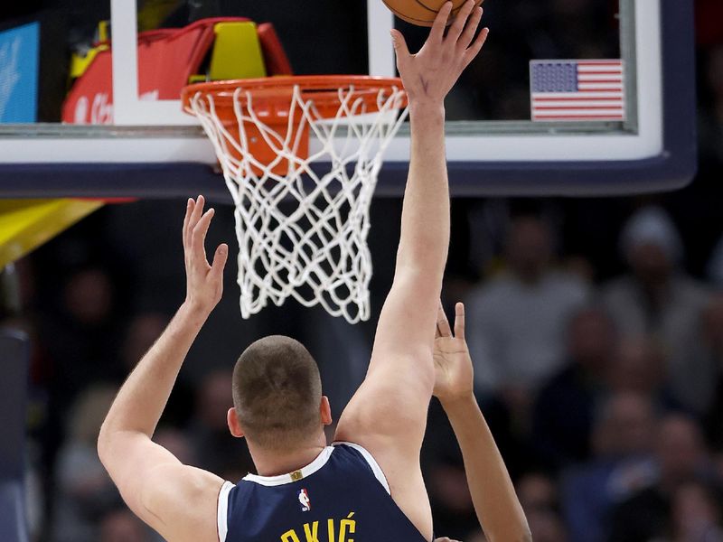 DENVER, COLORADO - FEBRUARY 22: Nikola Jokic #15 of the Denver Nuggets puts up a shot over Bilal Coulibaly #0 of the Washington Wizards in the first quarter at Ball Arena on February 22, 2024 in Denver, Colorado. NOTE TO USER: User expressly acknowledges and agrees that, by downloading and or using this photograph, User is consenting to the terms and conditions of the Getty Images License Agreement. (Photo by Matthew Stockman/Getty Images)