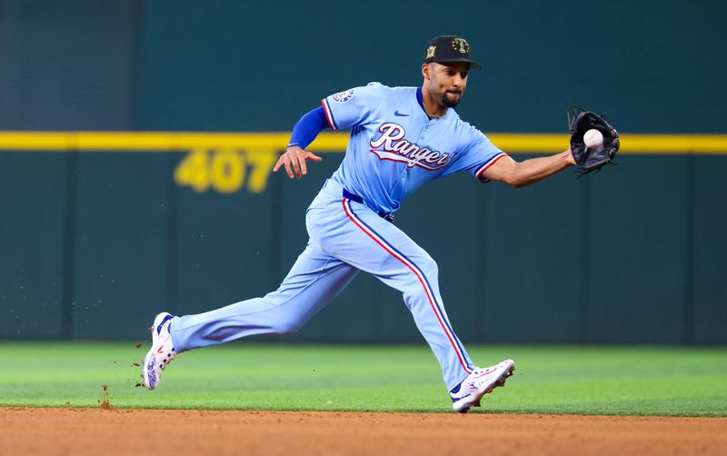 May 19, 2024; Arlington, Texas, USA; Texas Rangers second baseman Marcus Semien (2) fields a ground ball during the sixth inning against the Los Angeles Angels at Globe Life Field. Mandatory Credit: Kevin Jairaj-USA TODAY Sports