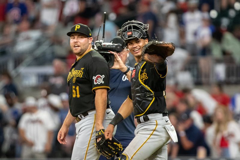 Sep 9, 2023; Cumberland, Georgia, USA; Pittsburgh Pirates relief pitcher David Bednar (51) and Pittsburgh Pirates catcher Endy Rodriguez (25) after win against Atlanta Braves at Truist Park. Mandatory Credit: Jordan Godfree-USA TODAY Sports