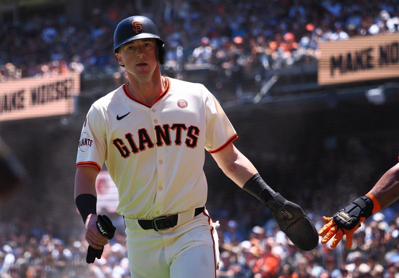 Jun 30, 2024; San Francisco, California, USA; San Francisco Giants second baseman Tyler Fitzgerald (49) high fives a teammate after scoring a run against the Los Angeles Dodgers during the second inning at Oracle Park. Mandatory Credit: Kelley L Cox-USA TODAY Sports