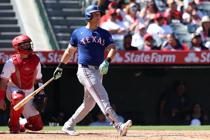 Sep 29, 2024; Anaheim, California, USA;  Texas Rangers first baseman Nathaniel Lowe (30) hits a home run during the eighth inning against the Los Angeles Angels at Angel Stadium. Mandatory Credit: Kiyoshi Mio-Imagn Images