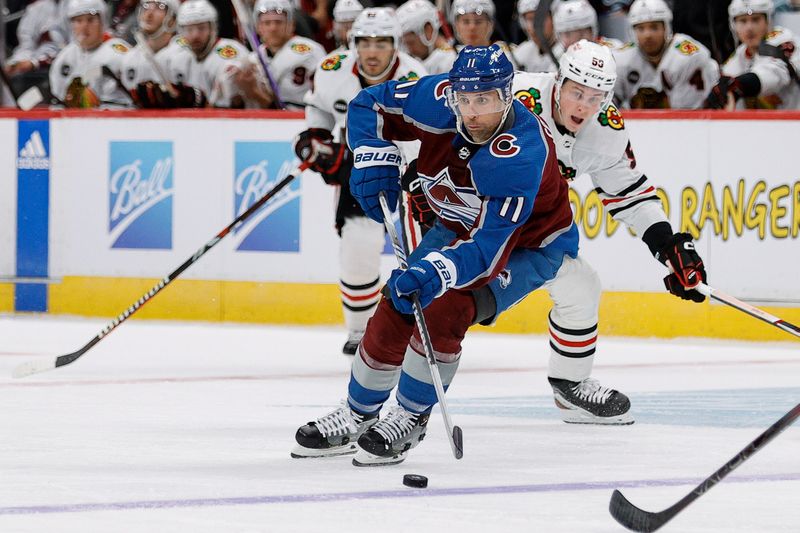 Oct 19, 2023; Denver, Colorado, USA; Colorado Avalanche center Andrew Cogliano (11) controls the puck in the second period against the Chicago Blackhawks at Ball Arena. Mandatory Credit: Isaiah J. Downing-USA TODAY Sports