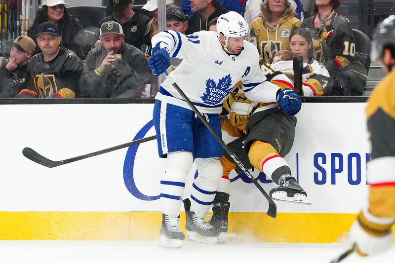 Jan 15, 2026; Las Vegas, Nevada, USA; Toronto Maple Leafs center John Tavares (91) checks Vegas Golden Knights right wing Braeden Bowman (42) during the first period at T-Mobile Arena. Mandatory Credit: Stephen R. Sylvanie-Imagn Images