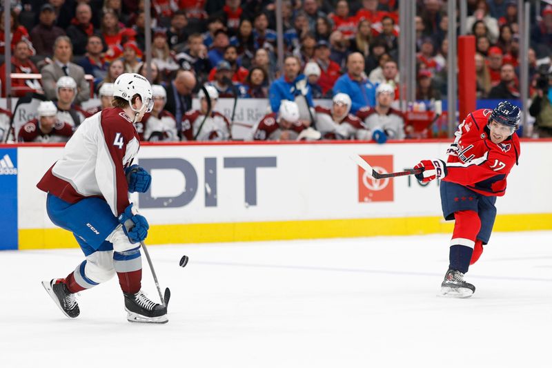 Feb 13, 2024; Washington, District of Columbia, USA; Washington Capitals center Dylan Strome (17) shoots the puck as Colorado Avalanche defenseman Bowen Byram (4) defends in the third period at Capital One Arena. Mandatory Credit: Geoff Burke-USA TODAY Sports