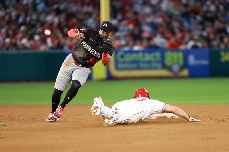 Apr 26, 2024; Anaheim, California, USA;  Los Angeles Angels outfielder Mike Trout (27) is called out at second base as he attempts to steal while Minnesota Twins shortstop Willi Castro (50) tags him during the fourth inning at Angel Stadium. Mandatory Credit: Kiyoshi Mio-USA TODAY Sports