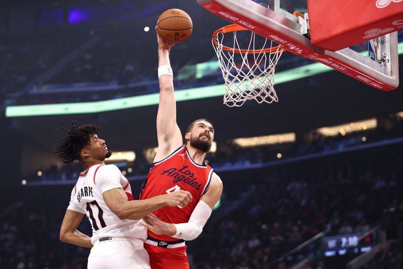 INGLEWOOD, CALIFORNIA - DECEMBER 03: Ivica Zubac #40 of the LA Clippers dunks over Shaedon Sharpe #17 of the Portland Trail Blazers during the first quarter of an Emirates NBA Cup game at Intuit Dome on December 03, 2024 in Inglewood, California. NOTE TO USER: User expressly acknowledges and agrees that, by downloading and or using this photograph, User is consenting to the terms and conditions of the Getty Images License Agreement. (Photo by Katelyn Mulcahy/Getty Images)