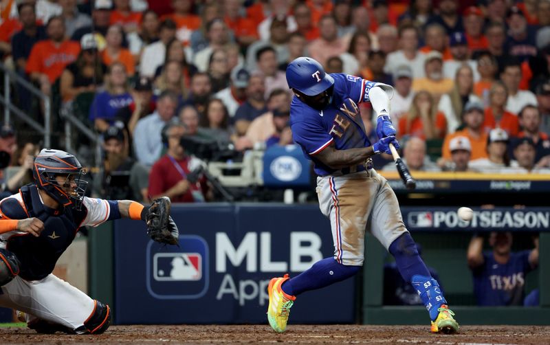 Oct 23, 2023; Houston, Texas, USA; Texas Rangers right fielder Adolis Garcia (53) hits a two-RBI single during the fourth inning of game seven in the ALCS against the Houston Astros for the 2023 MLB playoffs at Minute Maid Park. Mandatory Credit: Thomas Shea-USA TODAY Sports