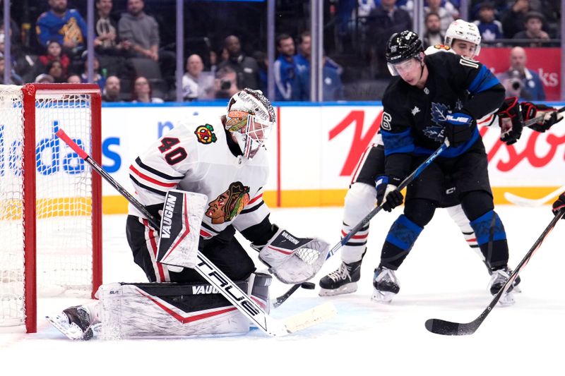 Dec 2, 2024; Toronto, Ontario, CAN; Toronto Maple Leafs forward Mitch Marner (16) tries to tip a puck past Chicago Blackhawks goaltender Arvid Soderblom (40) during the first period at Scotiabank Arena. Mandatory Credit: John E. Sokolowski-Imagn Images