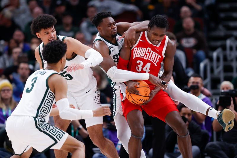 Mar 10, 2023; Chicago, IL, USA; Ohio State Buckeyes center Felix Okpara (34) grabs a rebound against Michigan State Spartans forward Malik Hall (25) during the second half at United Center. Mandatory Credit: Kamil Krzaczynski-USA TODAY Sports