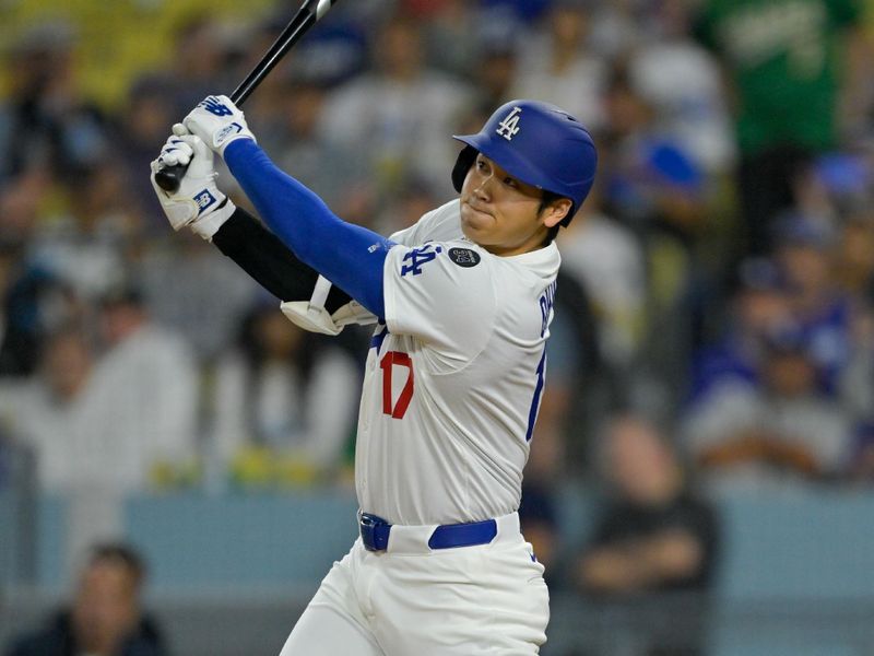 May 15, 2025; Los Angeles, California, USA; Los Angeles Dodgers designated hitter Shohei Ohtani (17) hits a three-run home run against the Athletics during the third inning of the game at Dodger Stadium. Mandatory Credit: Jayne Kamin-Oncea-Imagn Images