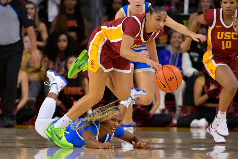 Jan 14, 2024; Los Angeles, California, USA; USC Trojans guard JuJu Watkins (12) beats UCLA Bruins guard Charisma Osborne (20) to a loose ball in the second half at Galen Center. Mandatory Credit: Jayne Kamin-Oncea-USA TODAY Sports