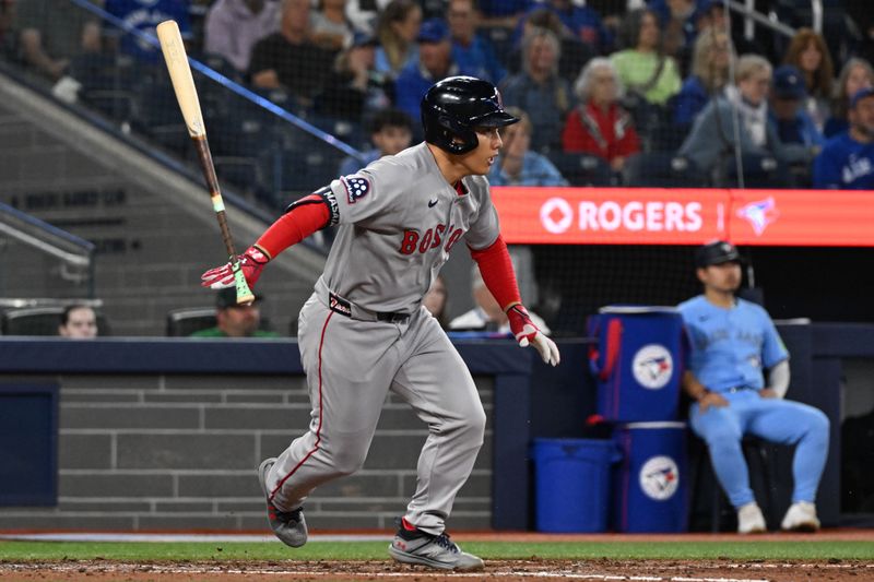 Sep 24, 2025; Toronto, Ontario, CAN;  Boston Red Sox designated hitter Masataka Yoshida (7) loses his bat as he grounds out against the Toronto Blue Jays in the seventh inning at Rogers Centre. Mandatory Credit: Dan Hamilton-Imagn Images