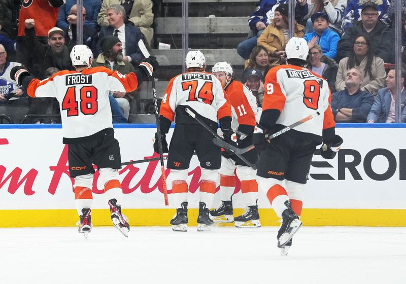 Feb 15, 2024; Toronto, Ontario, CAN; Philadelphia Flyers right wing Travis Konecny (11) scores a goal and celebrates with Philadelphia Flyers right wing Owen Tippett (74) against the Toronto Maple Leafs during the third period at Scotiabank Arena. Mandatory Credit: Nick Turchiaro-USA TODAY Sports