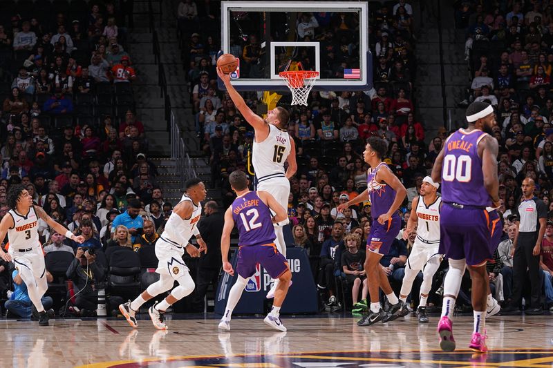 DENVER, CO - OCTOBER 13: Nikola Jokic #15 of the Denver Nuggets goes up for the rebound during the game against the Phoenix Suns on October 13, 2024 at Ball Arena in Denver, Colorado. NOTE TO USER: User expressly acknowledges and agrees that, by downloading and/or using this Photograph, user is consenting to the terms and conditions of the Getty Images License Agreement. Mandatory Copyright Notice: Copyright 2024 NBAE (Photo by Bart Young/NBAE via Getty Images)