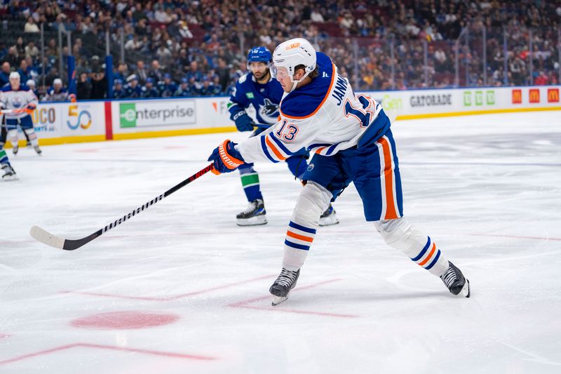 Oct 4, 2024; Vancouver, British Columbia, CAN; Edmonton Oilers forward Mattias Janmark (13) shoots against the Vancouver Canucks during the second period at Rogers Arena. Mandatory Credit: Bob Frid-Imagn Images