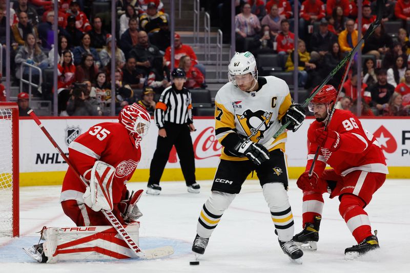 Oct 18, 2023; Detroit, Michigan, USA; Detroit Red Wings goaltender Ville Husso (35) makes a save in front of Pittsburgh Penguins center Sidney Crosby (87) in the third period at Little Caesars Arena. Mandatory Credit: Rick Osentoski-USA TODAY Sports