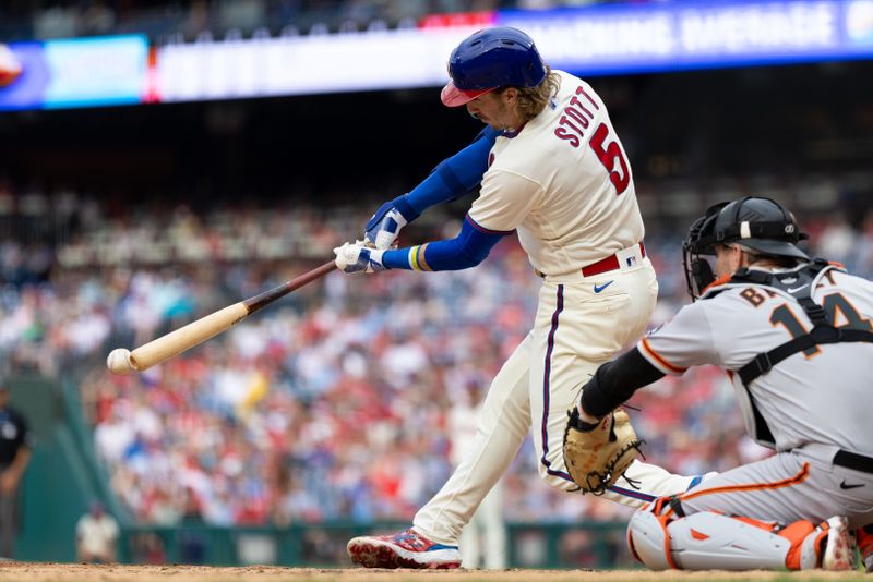 Aug 23, 2023; Philadelphia, Pennsylvania, USA; Philadelphia Phillies second baseman Bryson Stott (5) hits a single during the fifth inning against the San Francisco Giants at Citizens Bank Park. Mandatory Credit: Bill Streicher-USA TODAY Sports