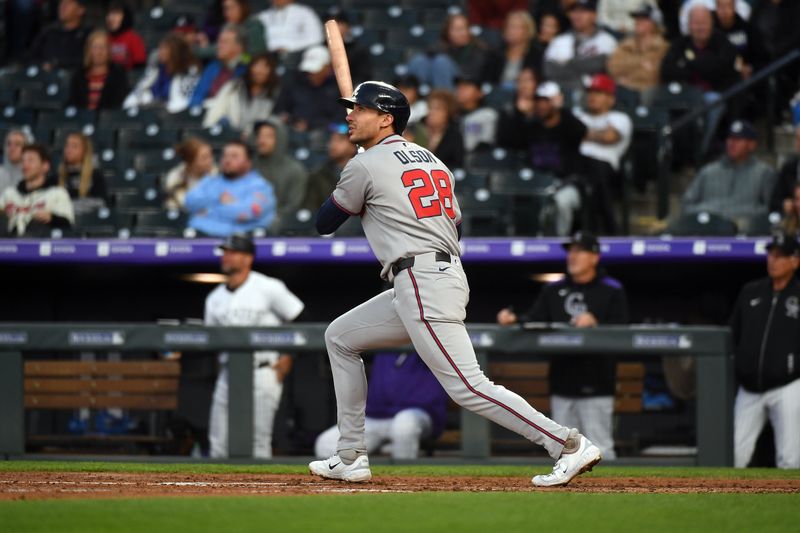 Apr 29, 2025; Denver, Colorado, USA; Atlanta Braves first base Matt Olson (28) hits a double during the fifth inning against the Colorado Rockies at Coors Field. Mandatory Credit: Christopher Hanewinckel-Imagn Images