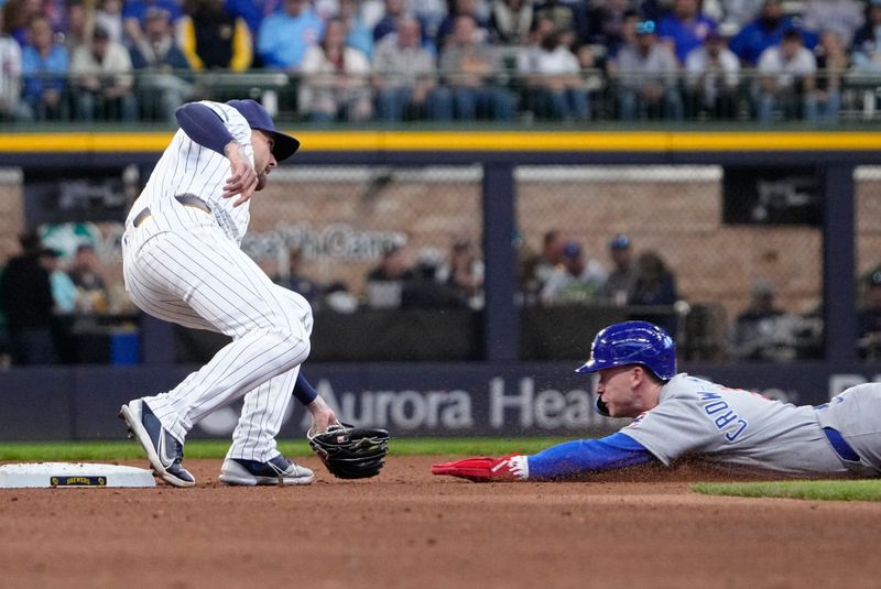 May 4, 2025; Milwaukee, Wisconsin, USA; Milwaukee Brewers second base Brice Turang (2) tags out Chicago Cubs outfielder Pete Crow-Armstrong (4) as he attempt to steal second base in the fifth inning at American Family Field. Mandatory Credit: Michael McLoone-Imagn Images