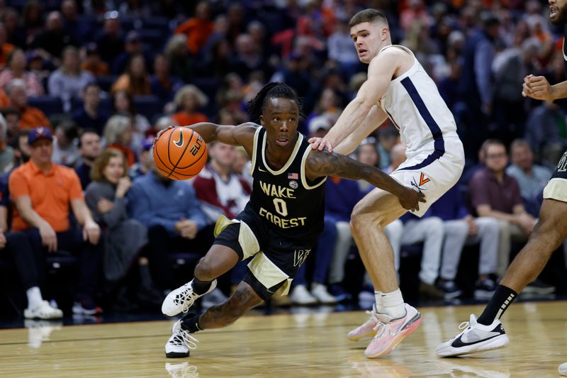 Feb 17, 2024; Charlottesville, Virginia, USA; Wake Forest Demon Deacons guard Kevin Miller (0) drives to the basket as Virginia Cavaliers guard Isaac McKneely (11) defends in the first half at John Paul Jones Arena. Mandatory Credit: Geoff Burke-USA TODAY Sports