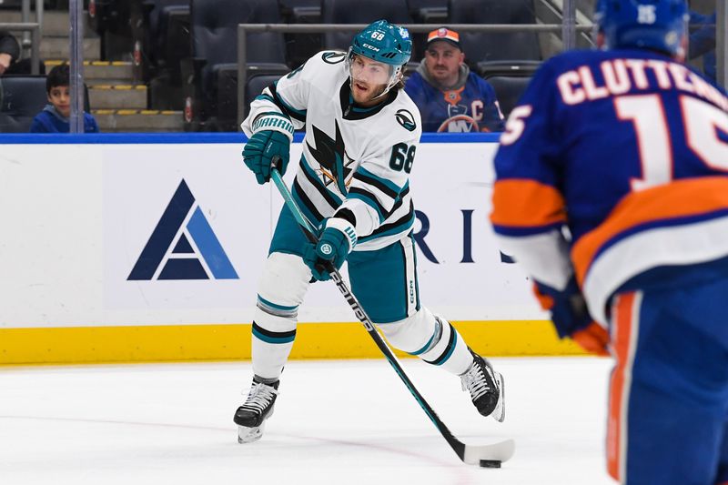 Dec 5, 2023; Elmont, New York, USA; San Jose Sharks center Mike Hoffman (68) attempts a shot against the New York Islanders during the first period at UBS Arena. Mandatory Credit: Dennis Schneidler-USA TODAY Sports