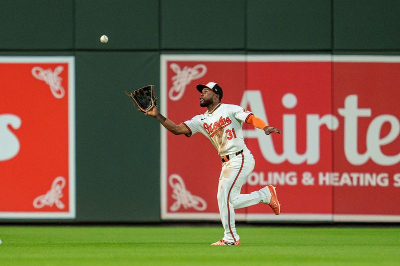 Jun 26, 2024; Baltimore, Maryland, USA; Baltimore Orioles outfielder Cedric Mullins (31) makes a catch during the seventh inning against the Cleveland Guardians at Oriole Park at Camden Yards. Mandatory Credit: Reggie Hildred-USA TODAY Sports