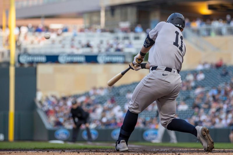 May 14, 2024; Minneapolis, Minnesota, USA; New York Yankees shortstop Anthony Volpe (11) hits a RBI single against the Minnesota Twins in the second inning at Target Field. Mandatory Credit: Jesse Johnson-USA TODAY Sports