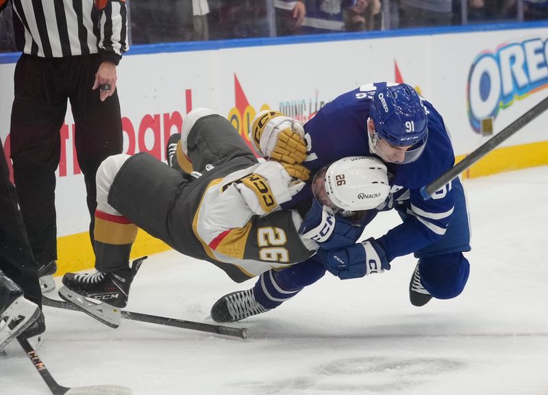 Nov 20, 2024; Toronto, Ontario, CAN; Toronto Maple Leafs forward John Tavares (91) takes down Vegas Golden Knights forward Alexander Holtz (26) during a scrum in the second period at Scotiabank Arena. Mandatory Credit: John E. Sokolowski-Imagn Images