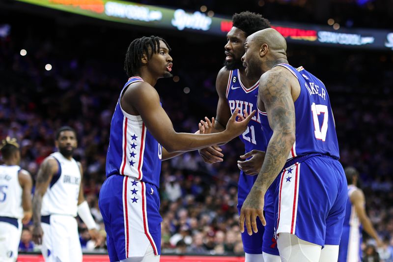 PHILADELPHIA, PENNSYLVANIA - MARCH 29: Tyrese Maxey #0, Joel Embiid #21 and P.J. Tucker #17 of the Philadelphia 76ers speak during the first quarter against the Dallas Mavericks at Wells Fargo Center on March 29, 2023 in Philadelphia, Pennsylvania. NOTE TO USER: User expressly acknowledges and agrees that, by downloading and or using this photograph, User is consenting to the terms and conditions of the Getty Images License Agreement. (Photo by Tim Nwachukwu/Getty Images)