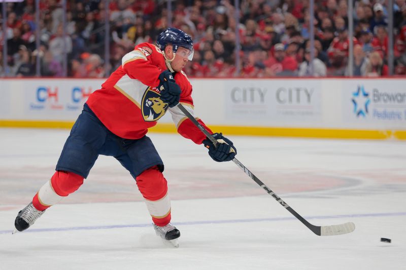 Apr 8, 2025; Sunrise, Florida, USA; Florida Panthers defenseman Nate Schmidt (88) shoots the puck against the Toronto Maple Leafs during the second period at Amerant Bank Arena. Mandatory Credit: Sam Navarro-Imagn Images