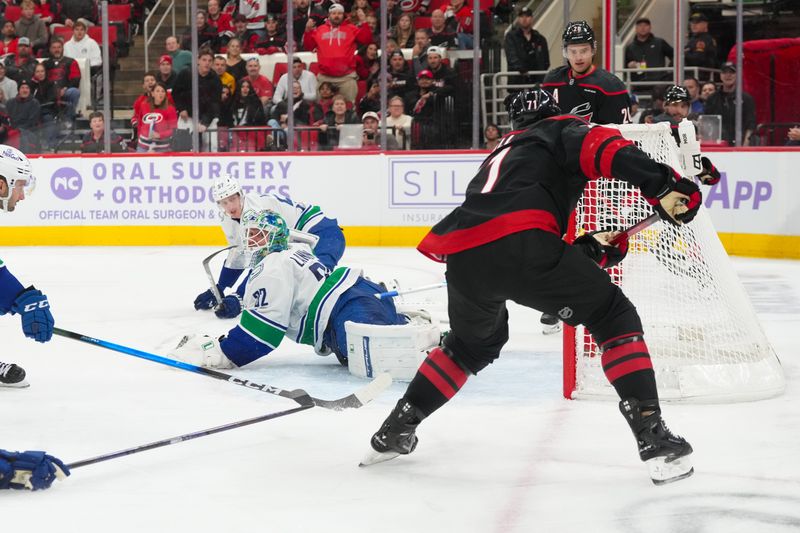 Nov 14, 2025; Raleigh, North Carolina, USA;  Carolina Hurricanes left wing Taylor Hall (71) scores a goal past Vancouver Canucks goaltender Kevin Lankinen (32) during the third period at Lenovo Center. Mandatory Credit: James Guillory-Imagn Images