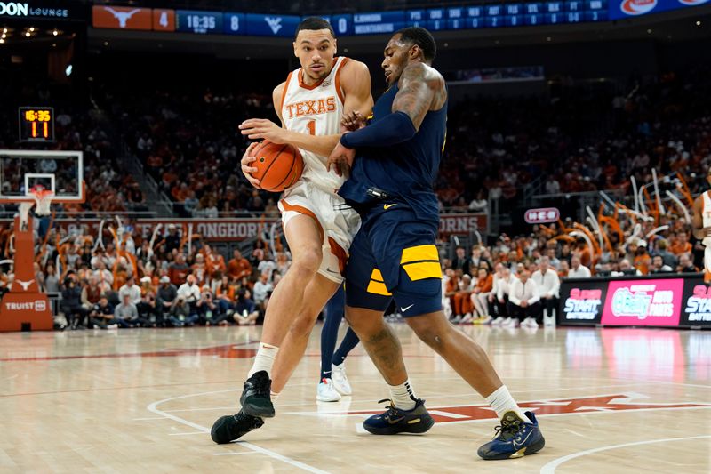 Feb 11, 2023; Austin, Texas, USA; Texas Longhorns forward Dylan Disu (1) drives to the basket against West Virginia Mountaineers forward Jimmy Bell Jr. (15) during the first half at Moody Center. Mandatory Credit: Scott Wachter-USA TODAY Sports