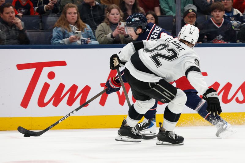 Mar 9, 2026; Columbus, Ohio, USA; Columbus Blue Jackets defenseman Zach Werenski (8) controls the puck past Los Angeles Kings right wing Taylor Ward (52) during the second period at Nationwide Arena. Mandatory Credit: Russell LaBounty-Imagn Images
