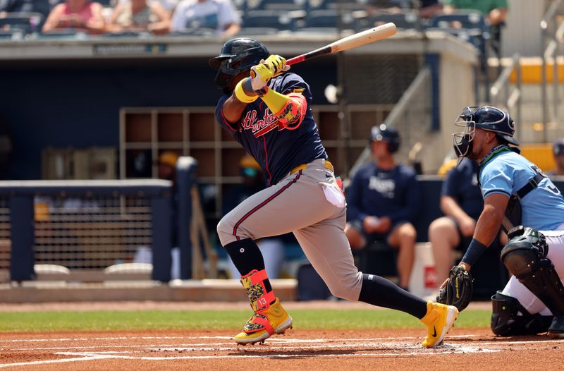 Mar 18, 2024; Port Charlotte, Florida, USA; Atlanta Braves outfielder Ronald Acuna Jr. (13) doubles during the first inning against the Tampa Bay Rays at Charlotte Sports Park. Mandatory Credit: Kim Klement Neitzel-USA TODAY Sports